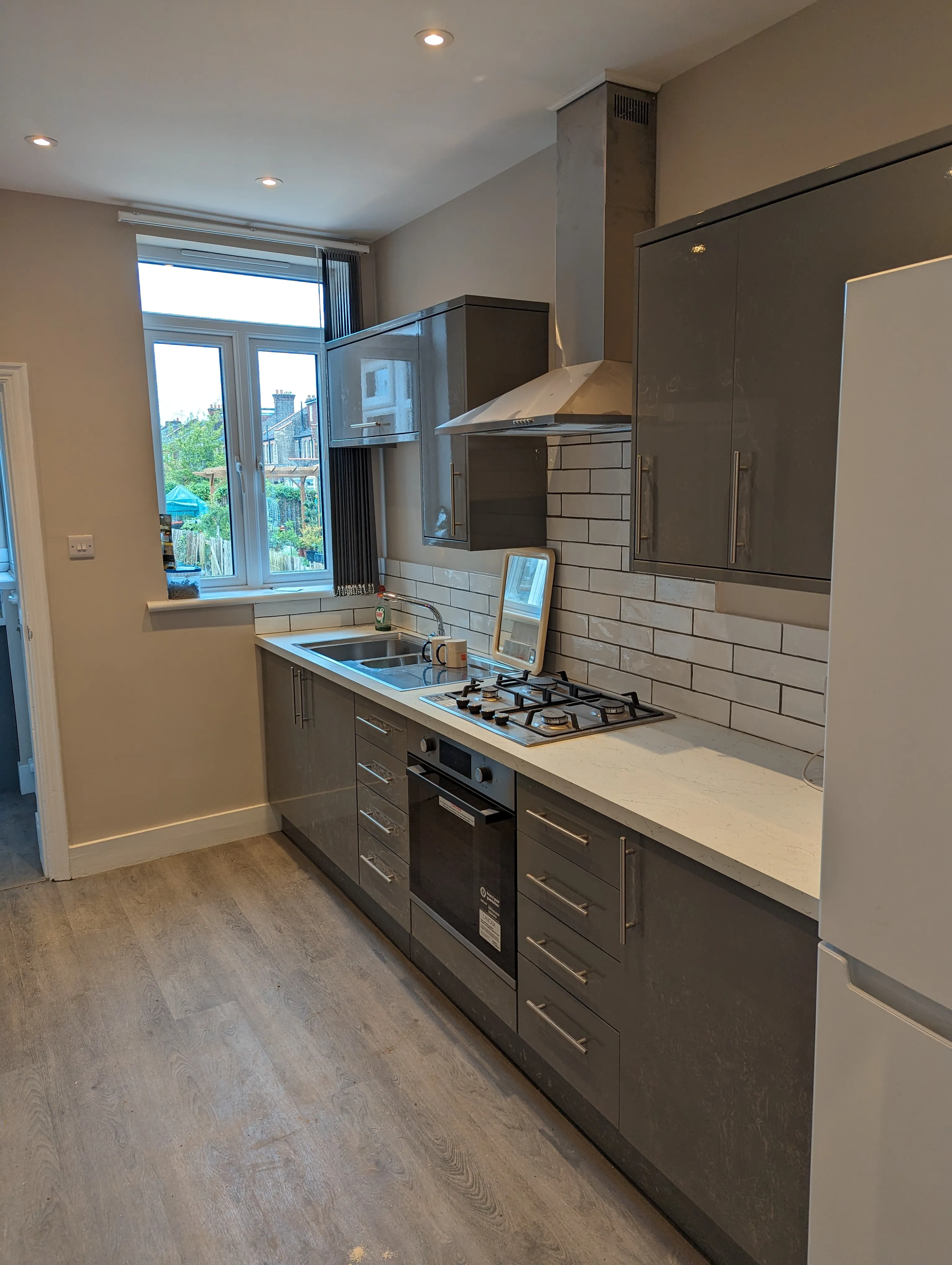 A kitchen with a stove top oven next to a window.